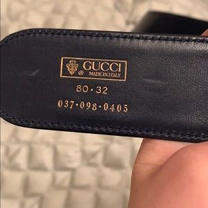Blue leather Gucci belt with a gold buckle.